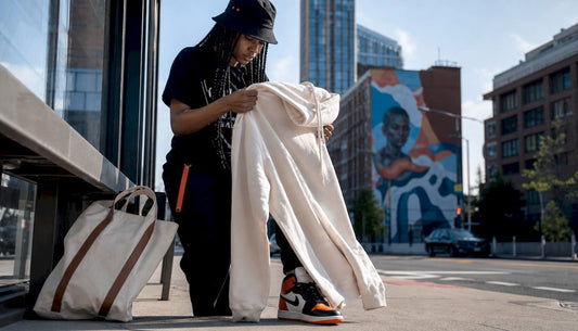 Woman inspecting quality streetwear hoodie outdoors