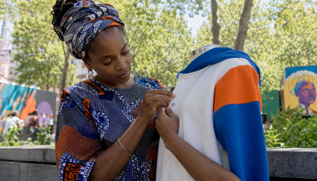 Fashion designer adjusting inclusive adaptive hoodie