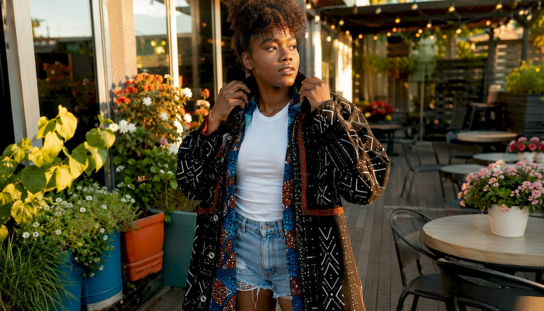 Woman layering African textiles in urban streetwear
