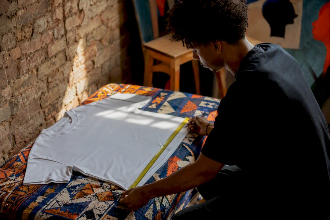 Measuring T-shirt length with tape measure